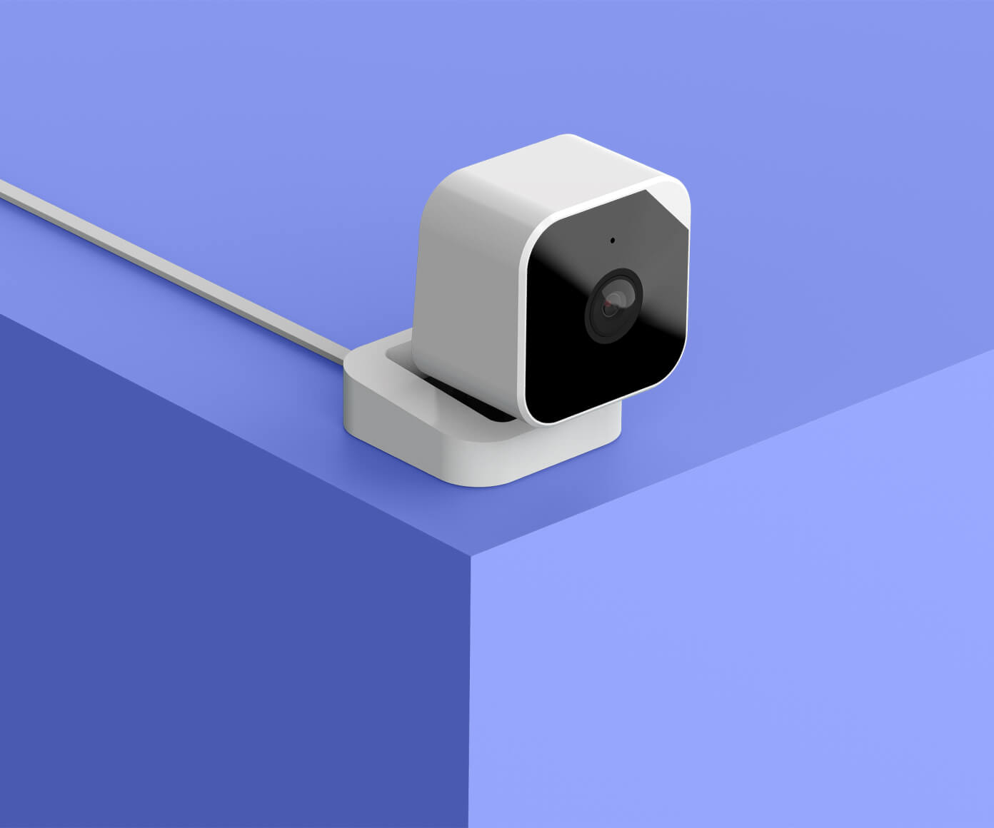 Hands holding Abode Cam 2 security camera outdoors