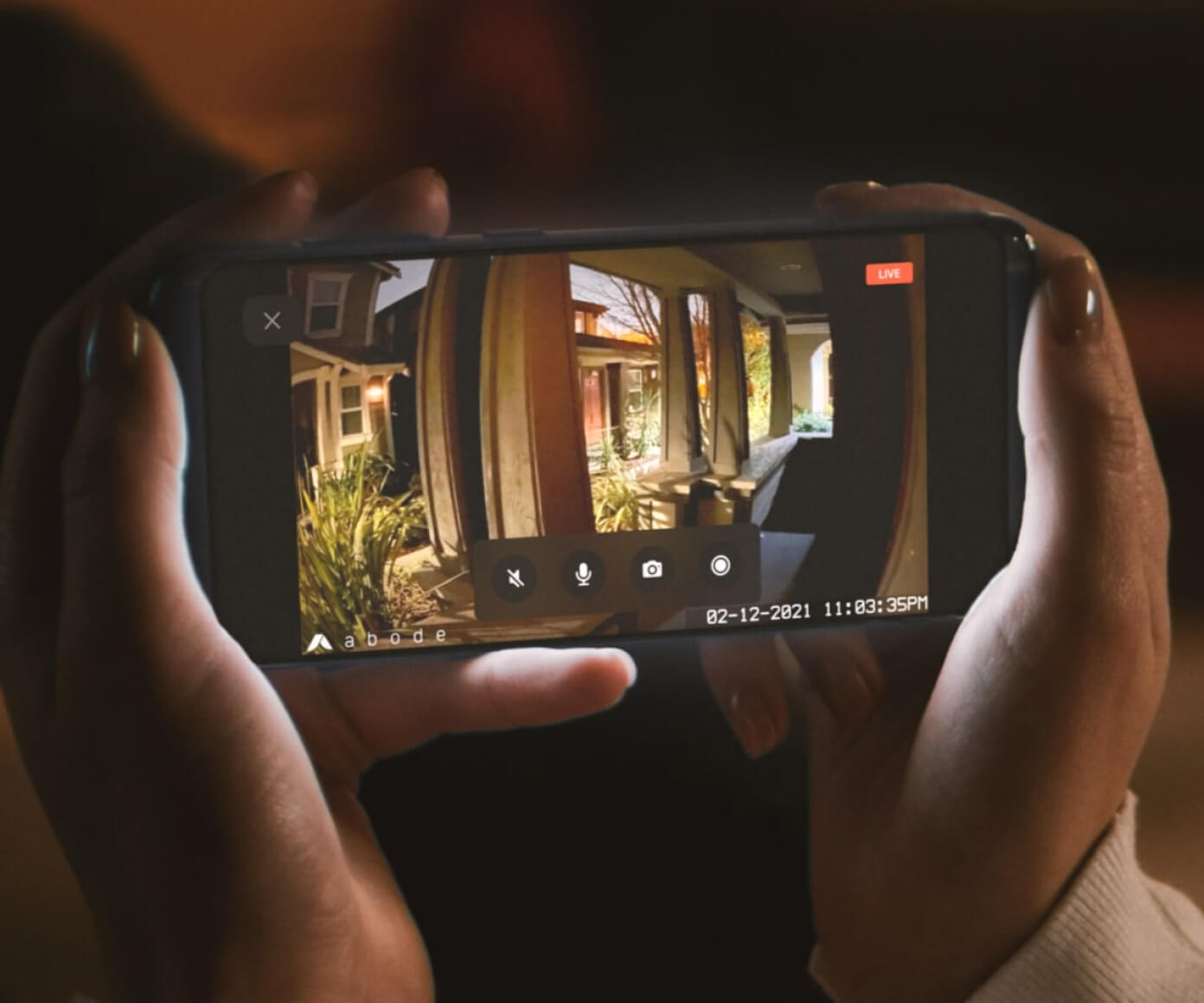 Smartphone showing live porch view from Abode Cam 2