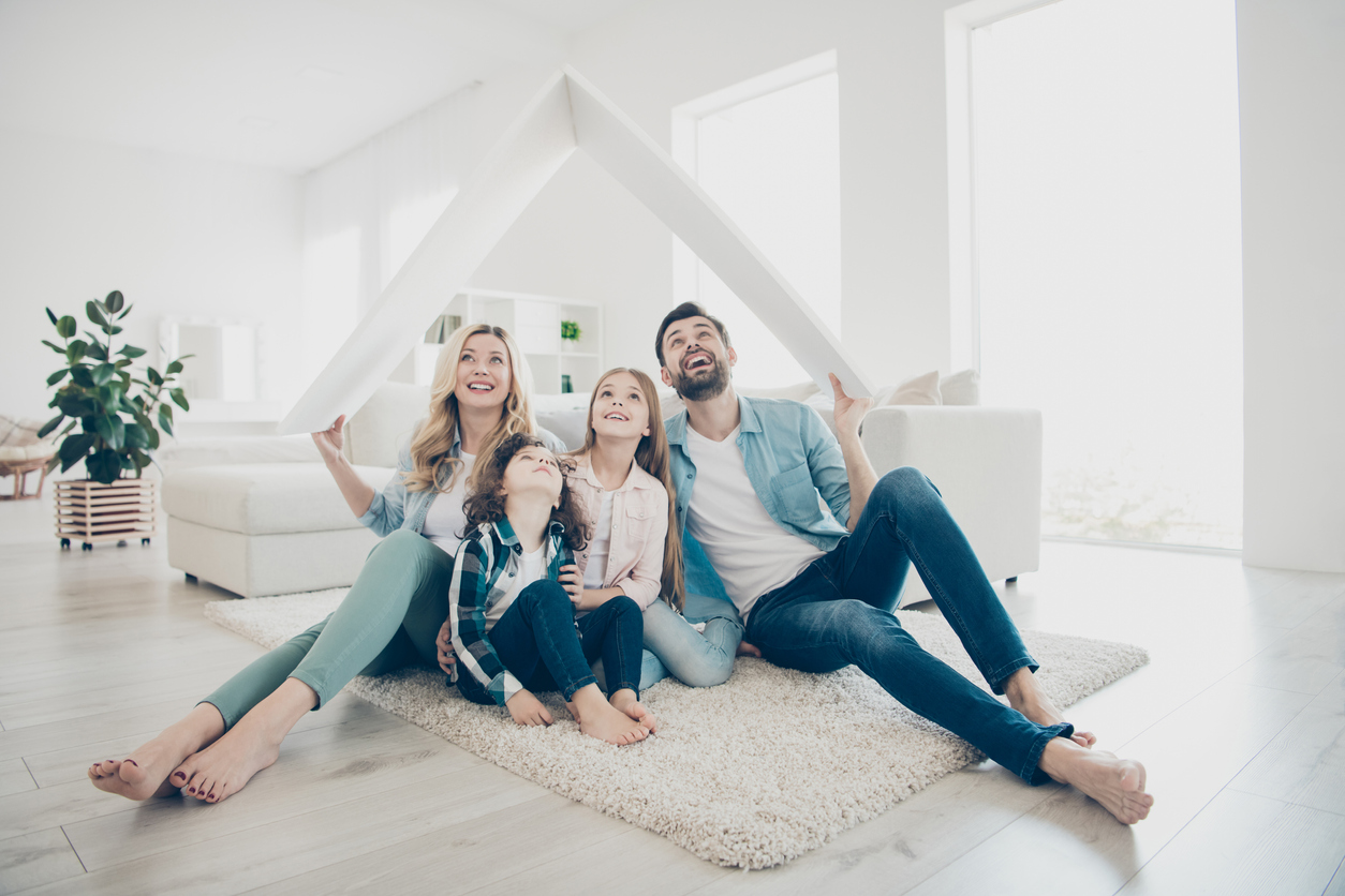 Photo of young family adopted two children move new apartments hold hands paper roof hoping best future
